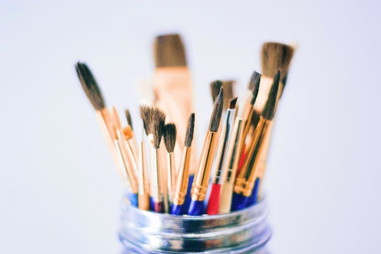 Collection of various paintbrushes in a jar ready for artistic projects.